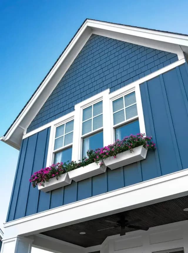 Blue Siding on a House with Planters in Front of Windows